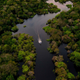 Aerial view showing a boat speeding on the Jurura river in the municipality of Carauari, in the heart of the Brazilian Amazon.